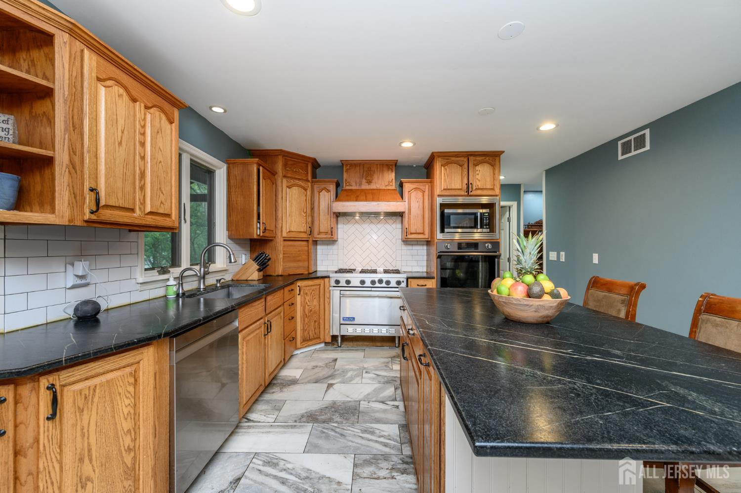 16 Pinewood Lane Washington, NJ 07882 - Photo 19 of 45 a kitchen with stainless steel appliances granite countertop a sink stove and refrigerator