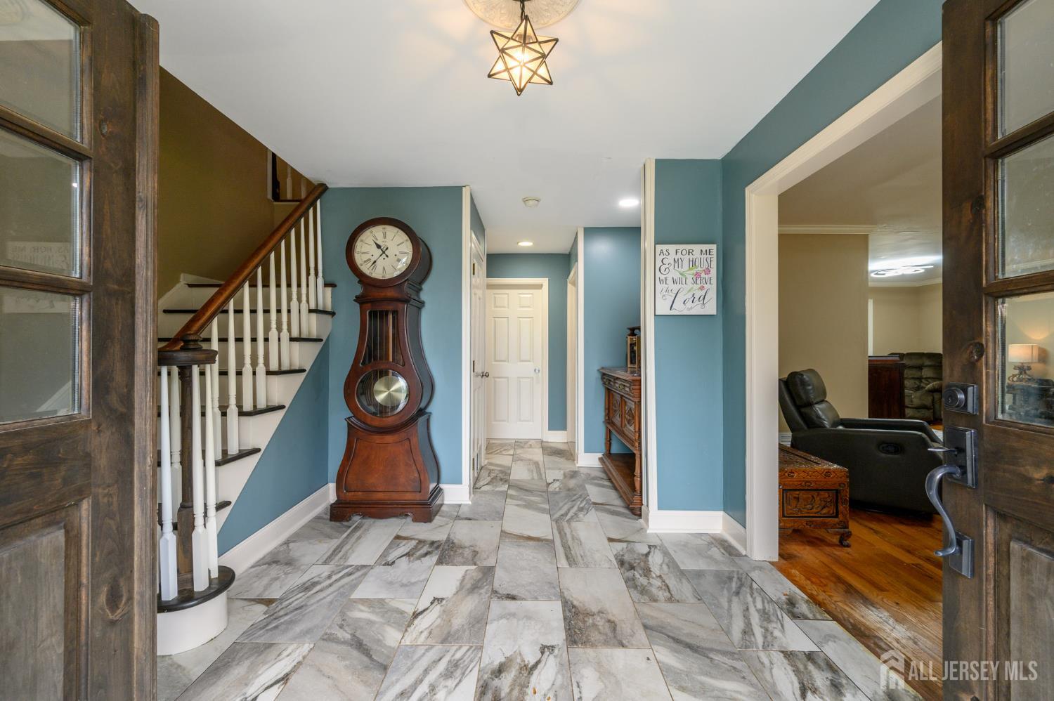 16 Pinewood Lane Washington, NJ 07882 - Photo 2 of 45 a view of hallway with wooden floor and a chandelier