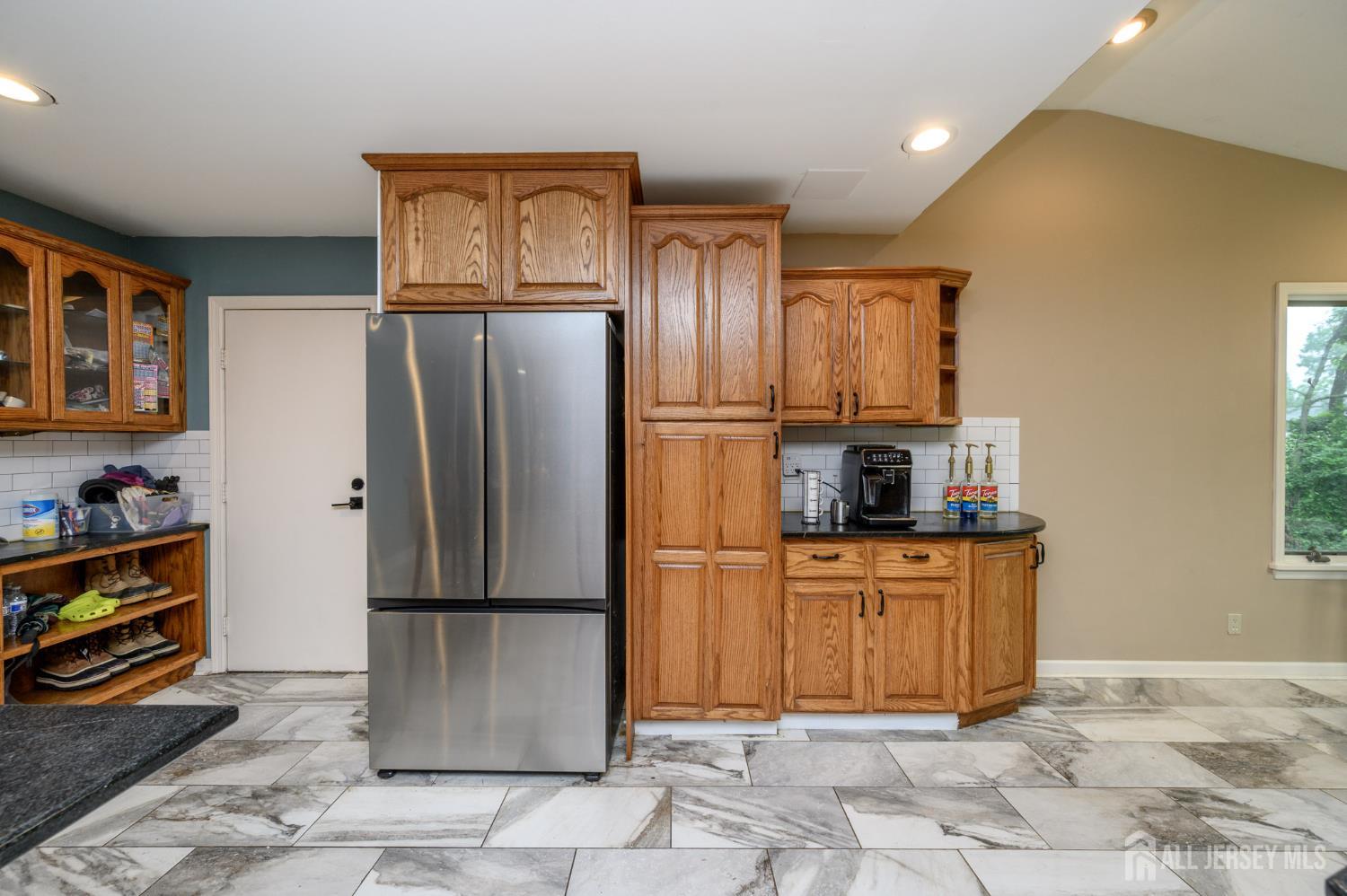 16 Pinewood Lane Washington, NJ 07882 - Photo 22 of 45 a kitchen with stainless steel appliances granite countertop a refrigerator and a stove top oven