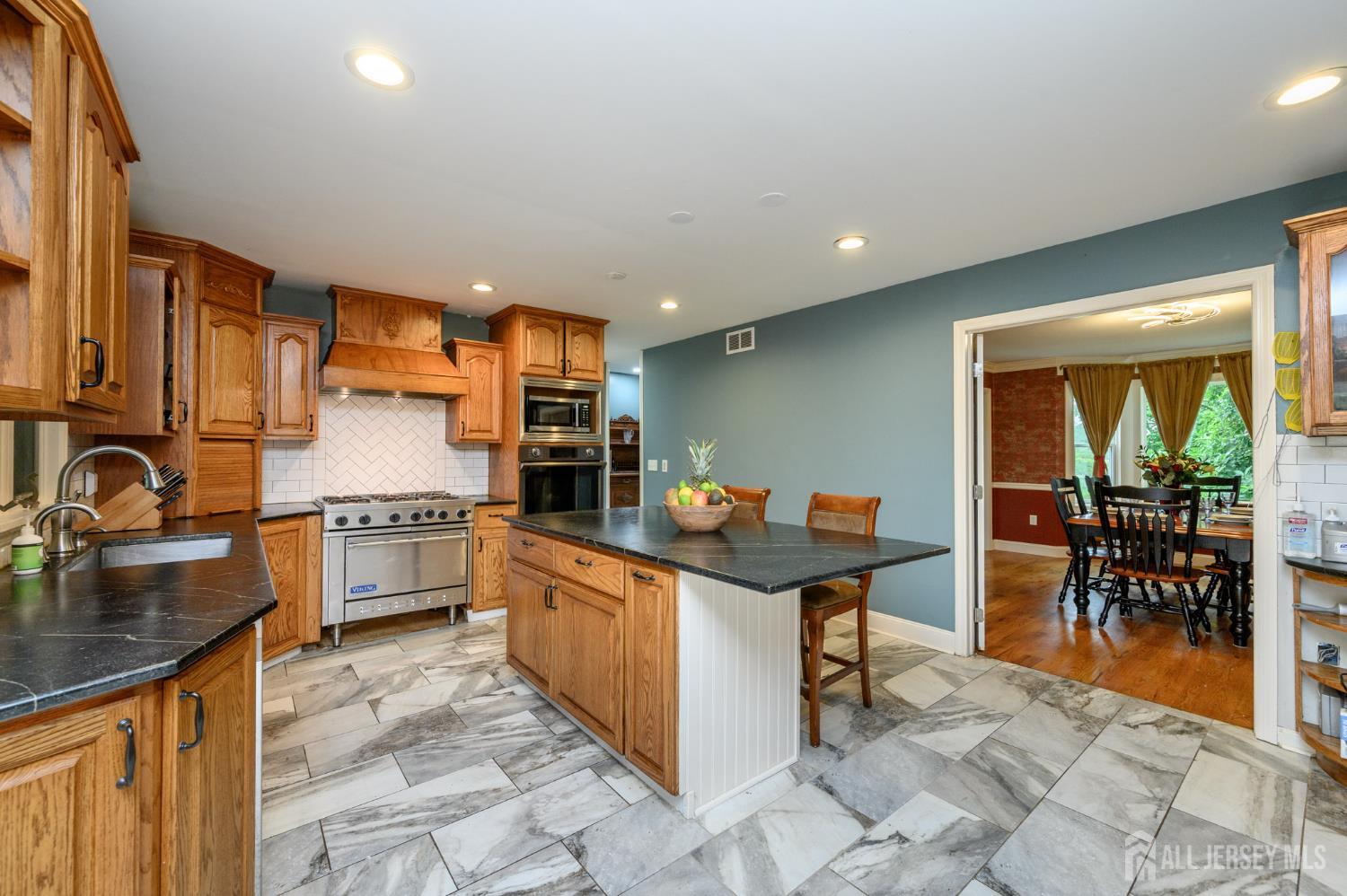 16 Pinewood Lane Washington, NJ 07882 - Photo 23 of 45 a kitchen with stainless steel appliances granite countertop sink stove and granite counter top
