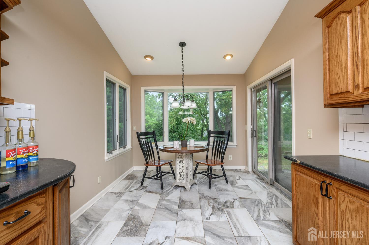 16 Pinewood Lane Washington, NJ 07882 - Photo 24 of 45 a dining room filled with furniture and large windows