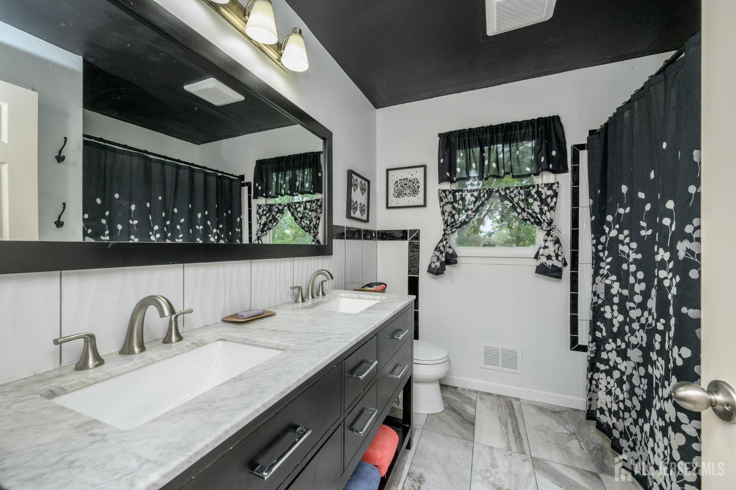 16 Pinewood Lane Washington, NJ 07882 - Photo 32 of 45 a bathroom with a double vanity sink mirror and shower