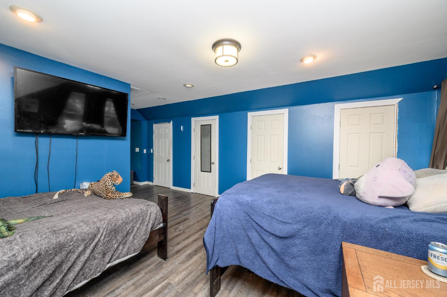 16 Pinewood Lane Washington, NJ 07882 - Photo 35 of 45 a bedroom with a large bed and a flat screen tv