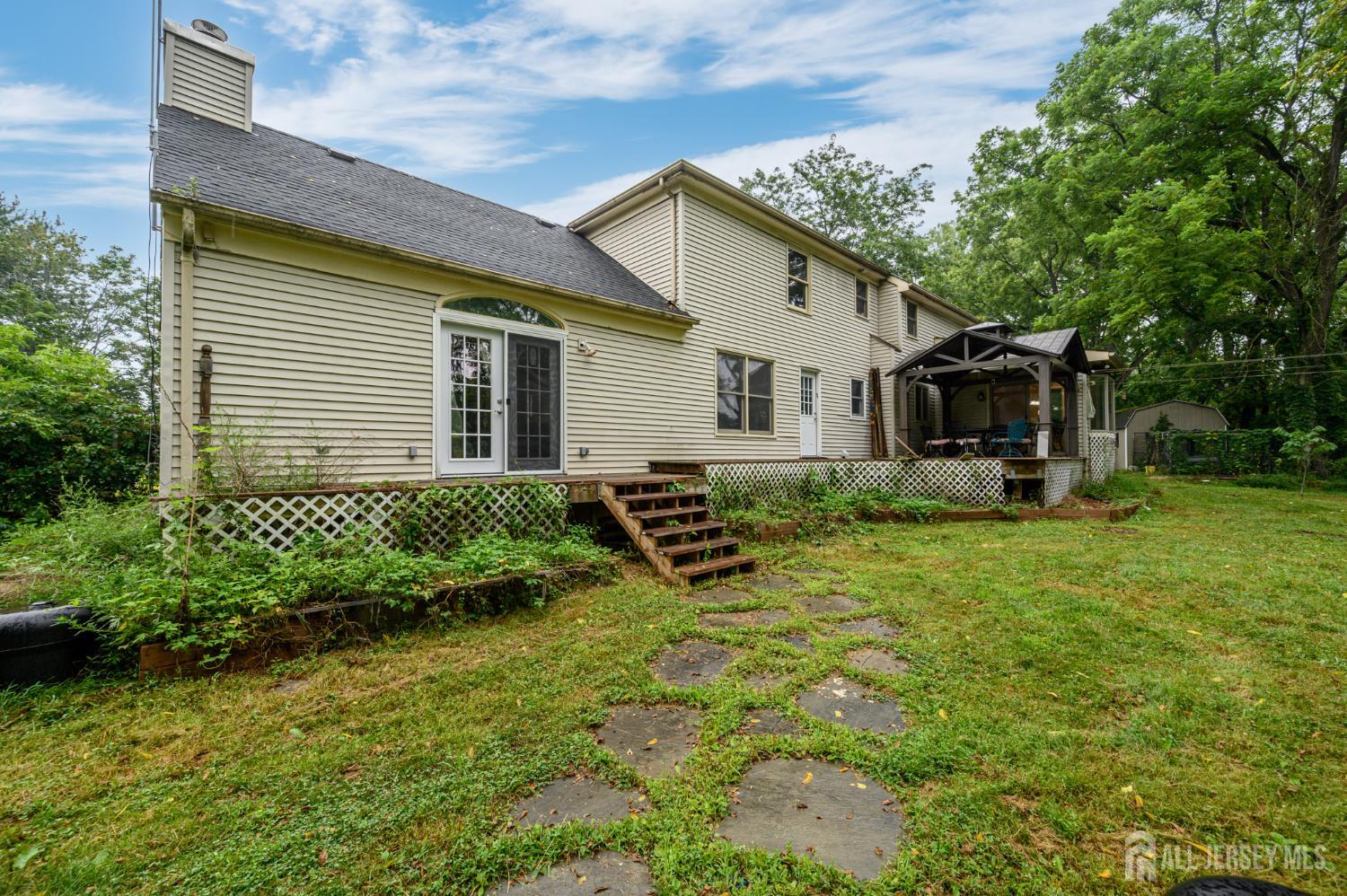 16 Pinewood Lane Washington, NJ 07882 - Photo 38 of 45 a view of a house with backyard and sitting area
