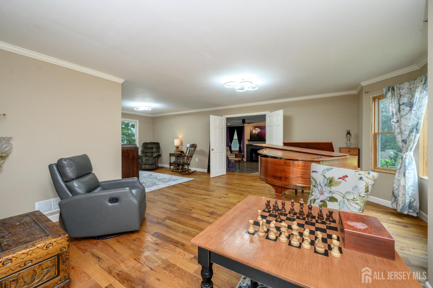 16 Pinewood Lane Washington, NJ 07882 - Photo 4 of 45 a living room with furniture and a dining table with wooden floor