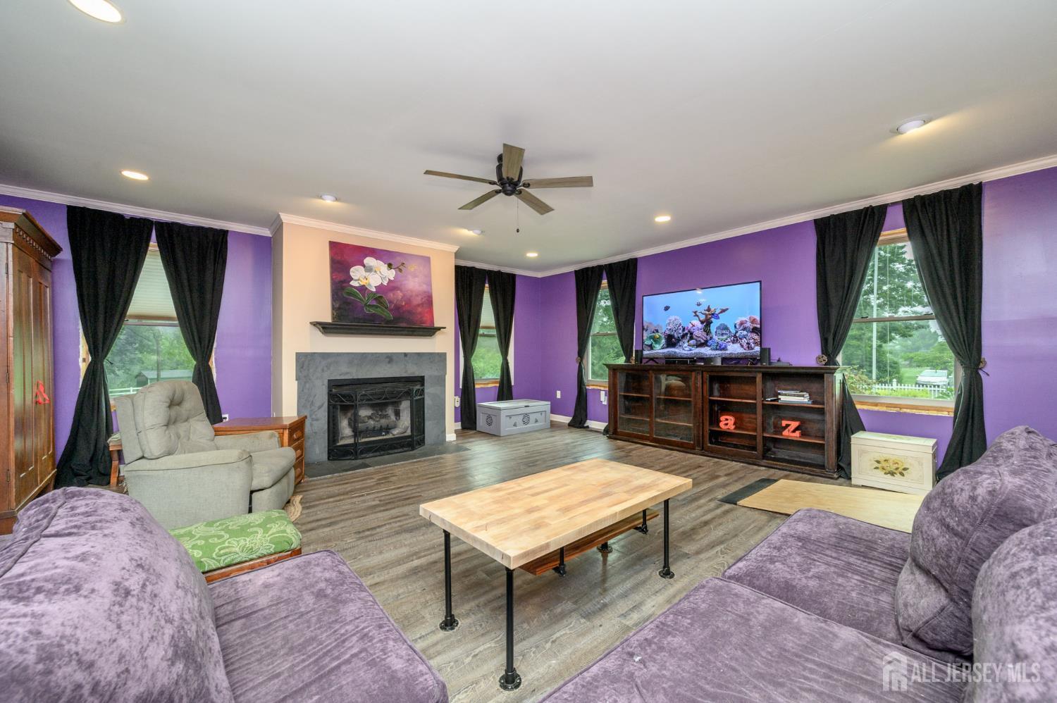 16 Pinewood Lane Washington, NJ 07882 - Photo 9 of 45 a living room with furniture a flat screen tv and a fireplace