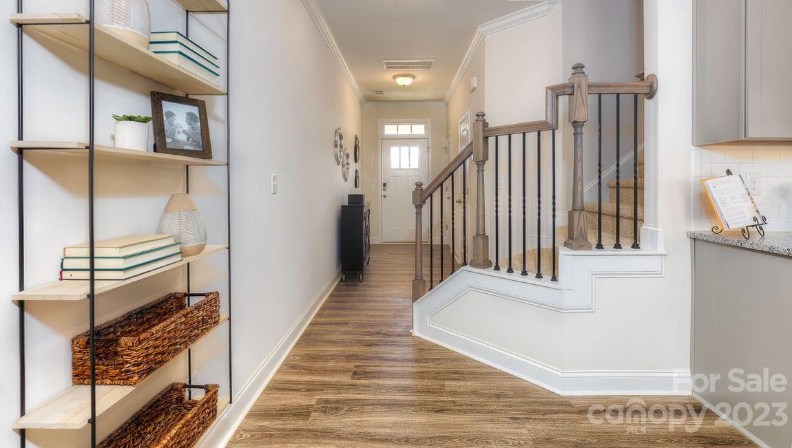 27 Ravens Rdg Road Hendersonville, NC 28792 - Photo 3 of 29 a view of staircase with lots of frames on wall and wooden floor