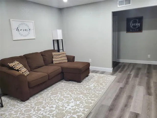 a living room with a couch and a rug