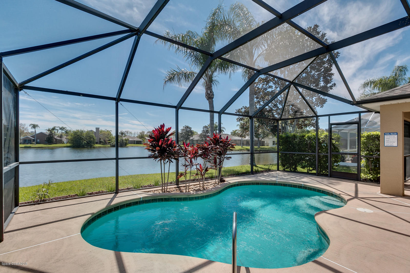 1253 Foxridge Place Melbourne, FL 32940 - Photo 2 of 22 a view of a swimming pool with a porch