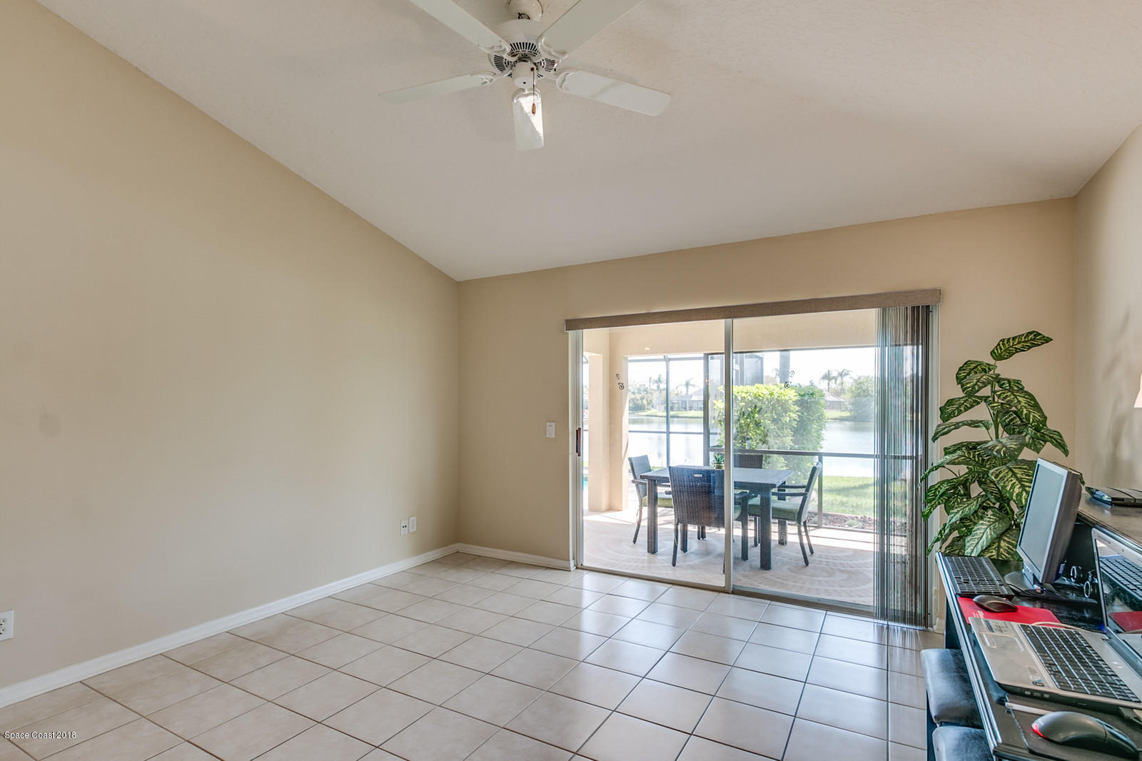 1253 Foxridge Place Melbourne, FL 32940 - Photo 11 of 22 a view of a livingroom with furniture potted plants and a chandelier