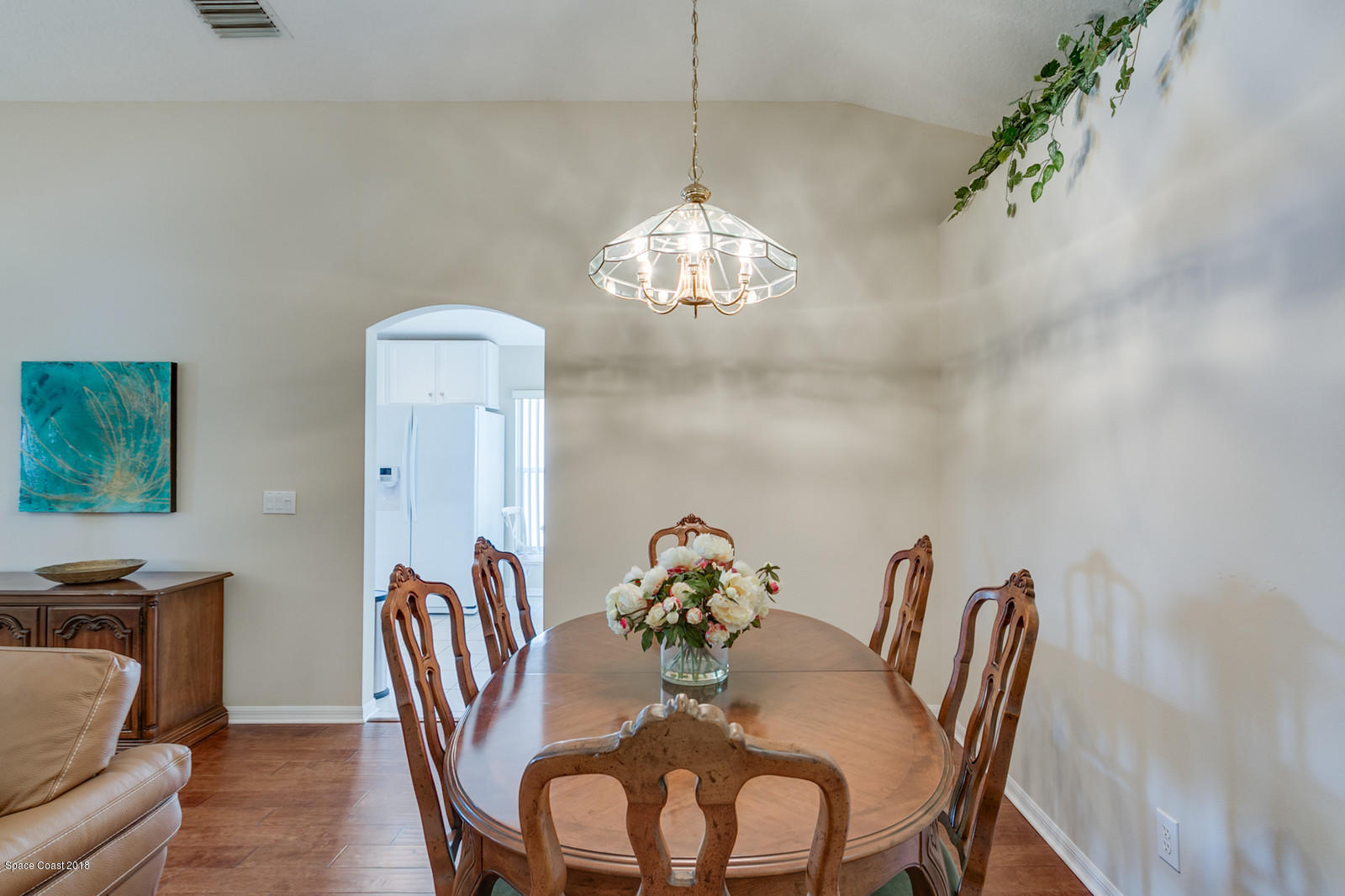 1253 Foxridge Place Melbourne, FL 32940 - Photo 12 of 22 a dining room with furniture and chandelier