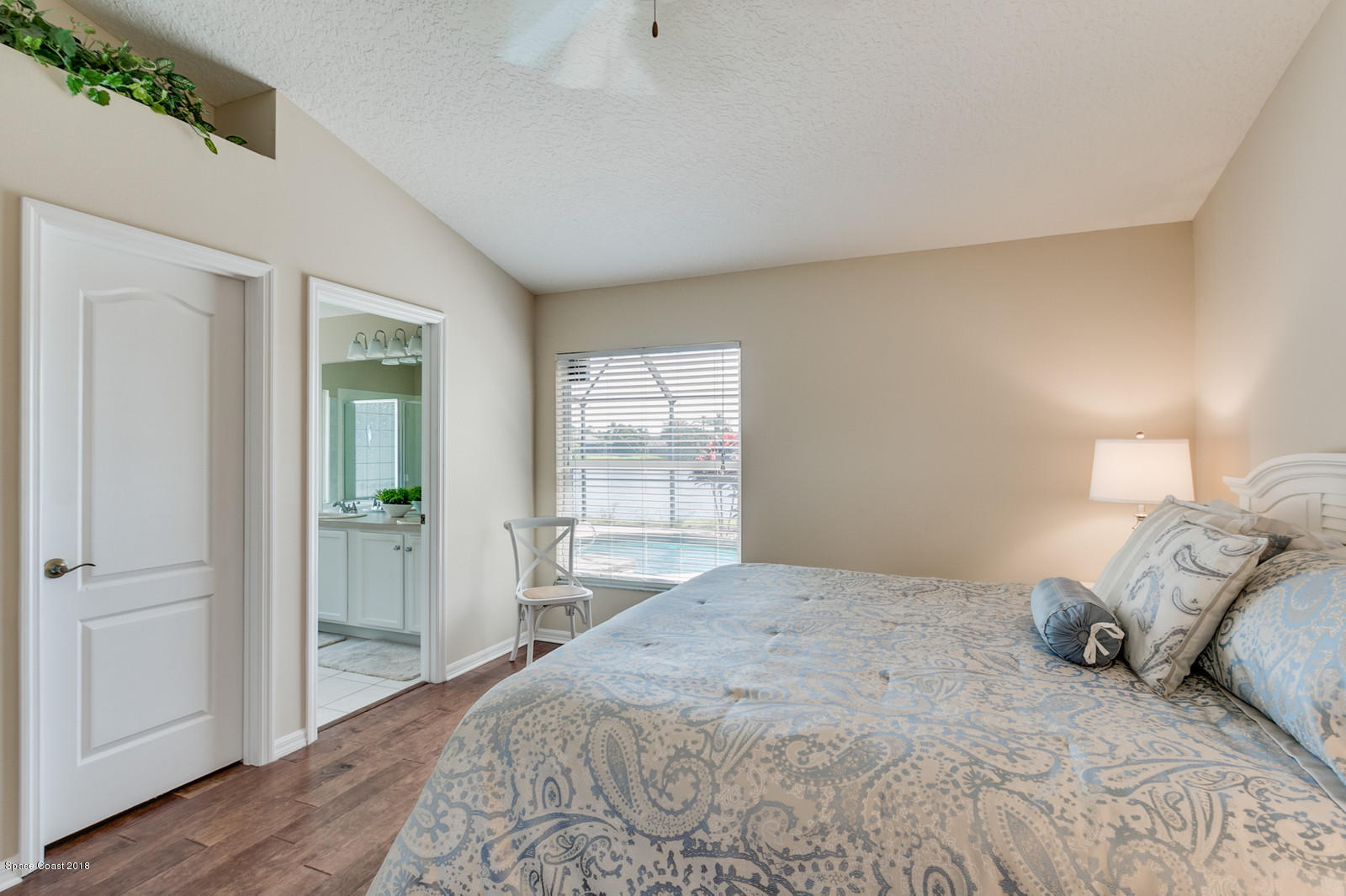 1253 Foxridge Place Melbourne, FL 32940 - Photo 13 of 22 a bedroom with a bed and a window