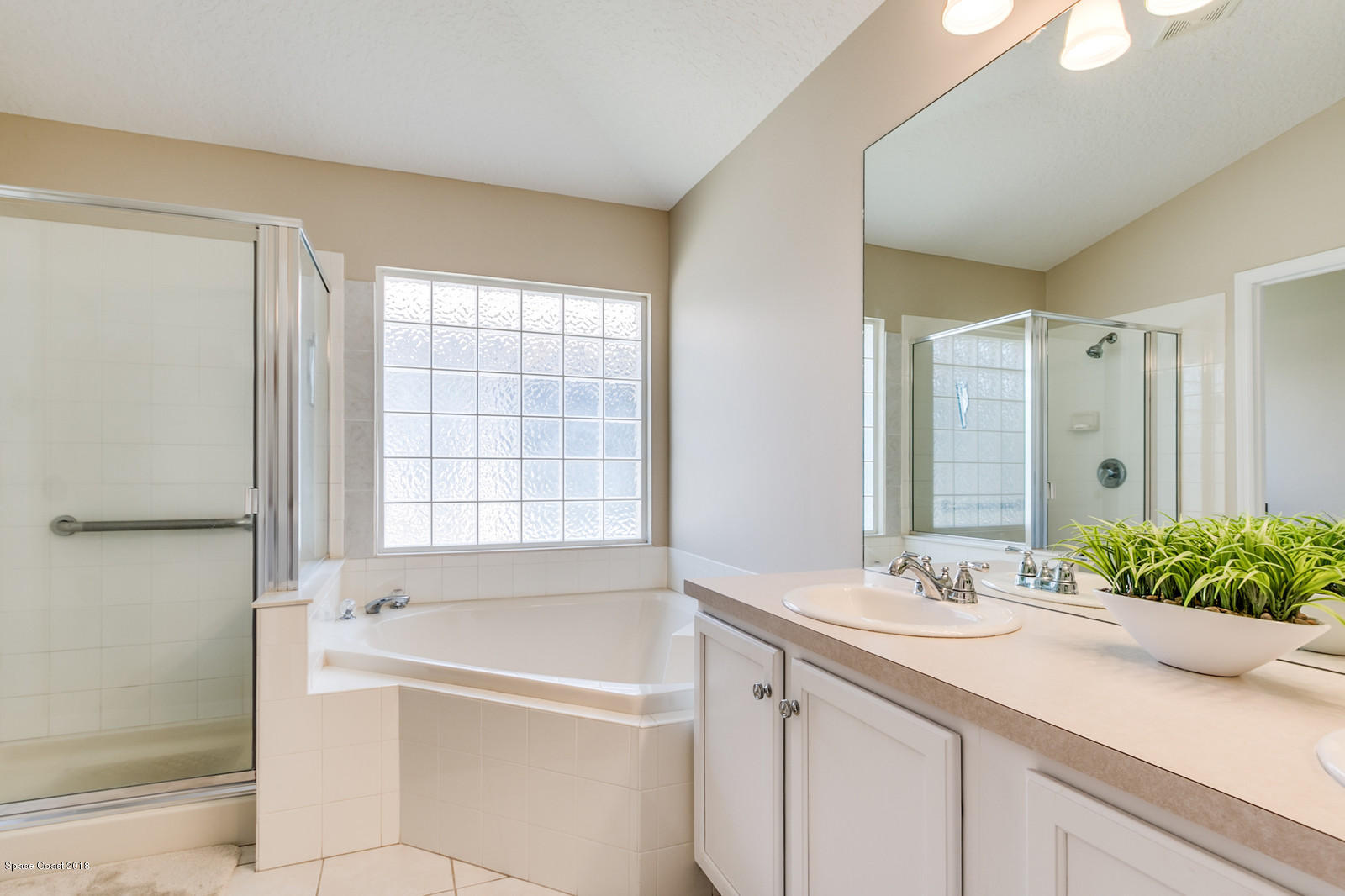 1253 Foxridge Place Melbourne, FL 32940 - Photo 15 of 22 a bathroom with a tub sink and mirror