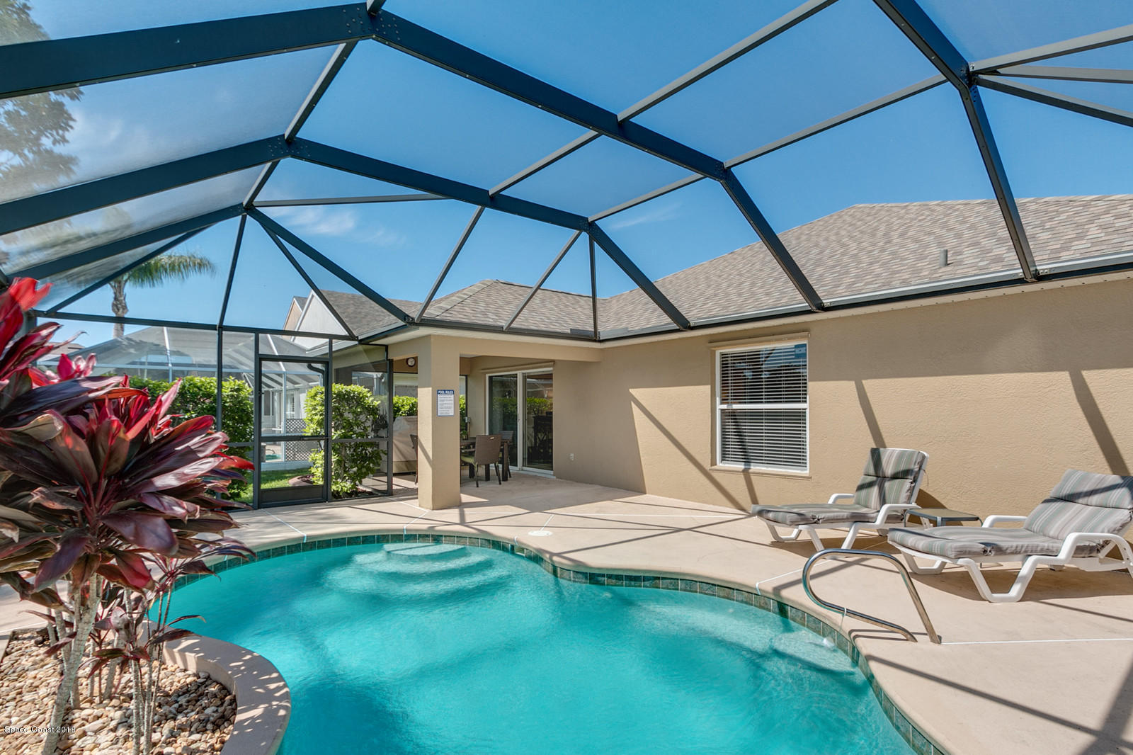 1253 Foxridge Place Melbourne, FL 32940 - Photo 19 of 22 a view of a patio with table and chairs under an umbrella