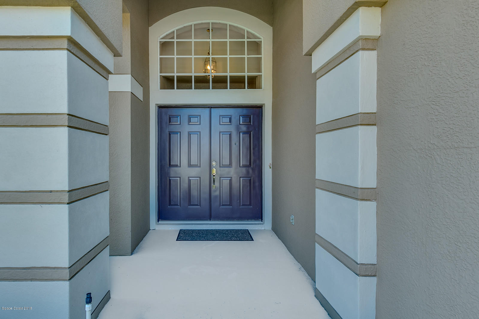 1253 Foxridge Place Melbourne, FL 32940 - Photo 4 of 22 a front view of a house with a glass door