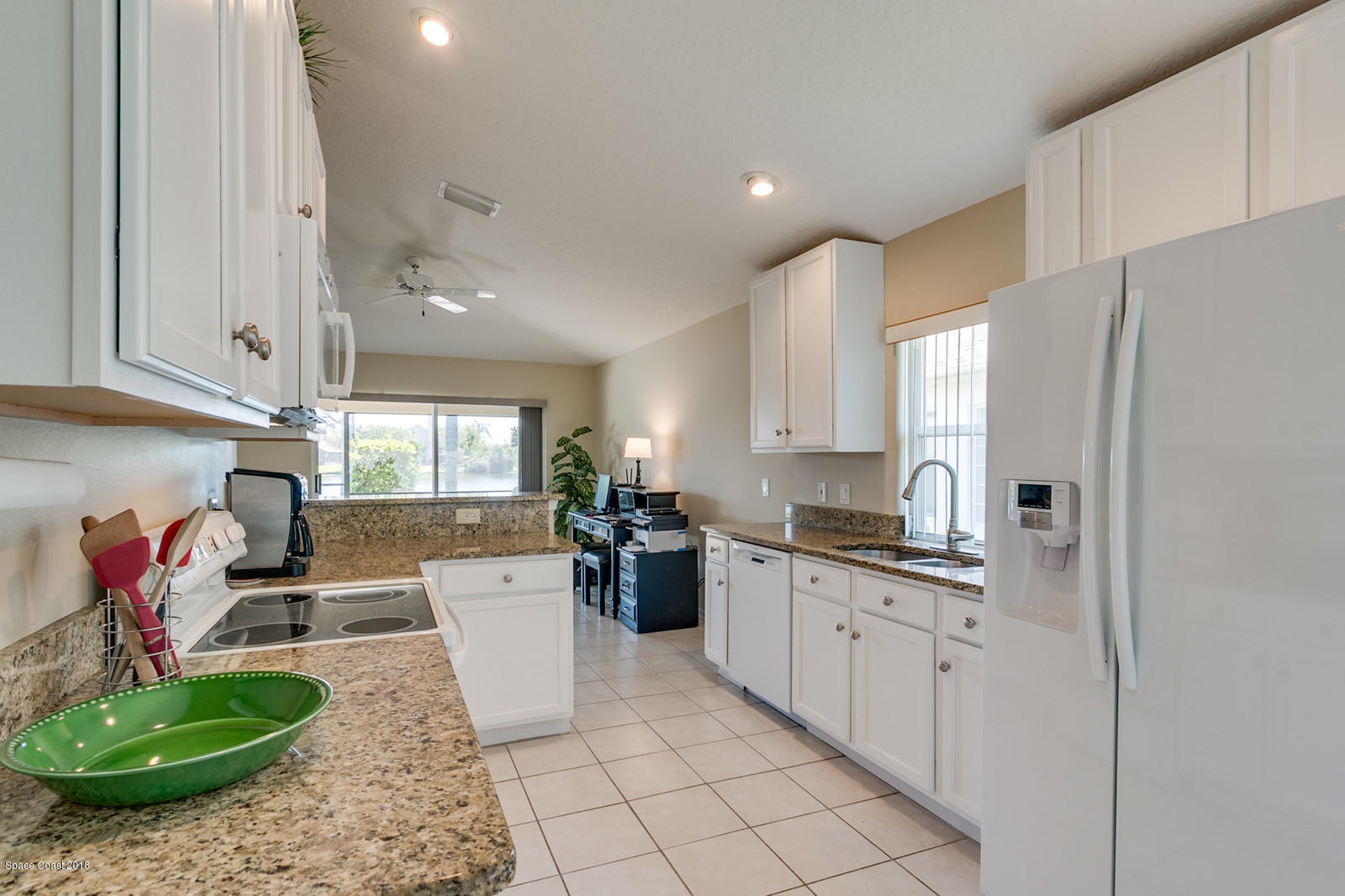 1253 Foxridge Place Melbourne, FL 32940 - Photo 6 of 22 a large kitchen with stainless steel appliances granite countertop a stove a sink and a refrigerator