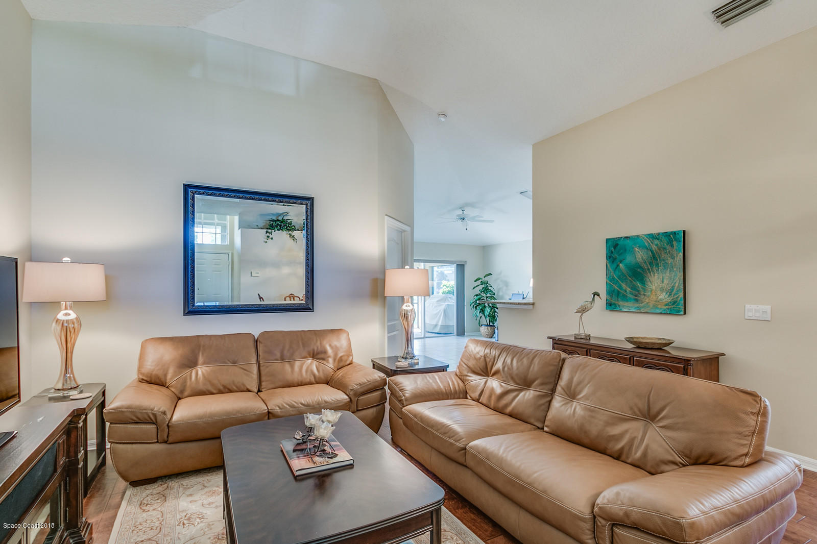1253 Foxridge Place Melbourne, FL 32940 - Photo 8 of 22 a living room with furniture a couch and wooden floor