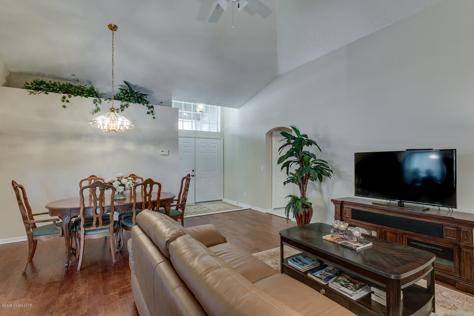1253 Foxridge Place Melbourne, FL 32940 - Photo 9 of 22 a living room with furniture and a flat screen tv
