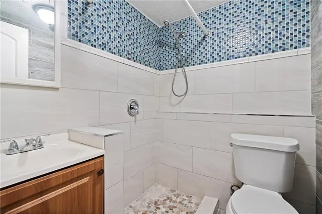 a bathroom with a sink toilet and shower