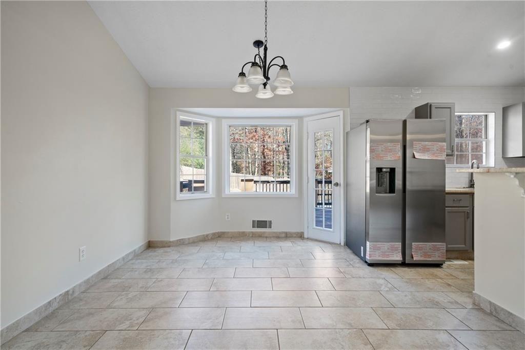 3323 Old Oaks Road Buford, GA 30519 - Photo 4 of 24 a view of an empty room with a window