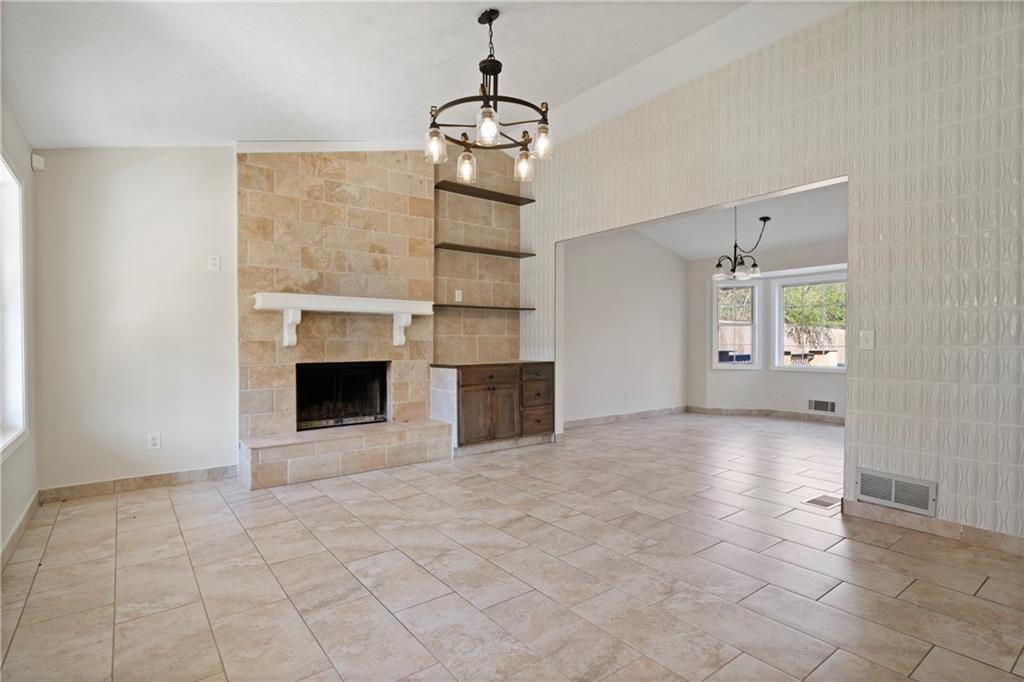 3323 Old Oaks Road Buford, GA 30519 - Photo 5 of 24 a view of an empty room with a fireplace and a window