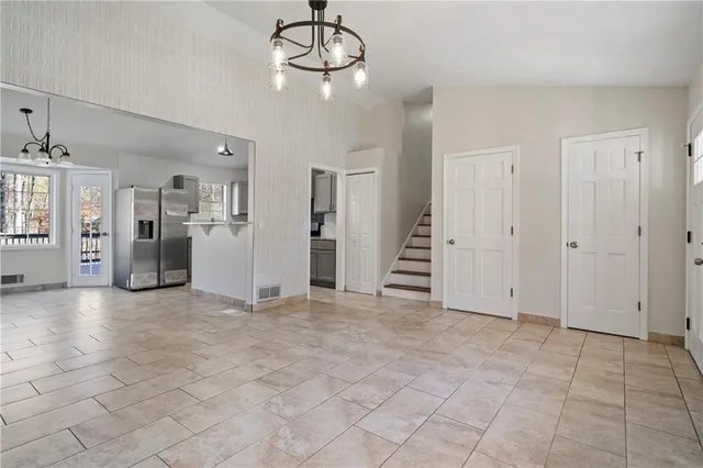 a view of an empty room with a kitchen