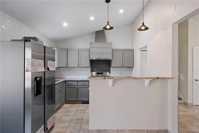 a kitchen with kitchen island a sink stainless steel appliances and cabinets