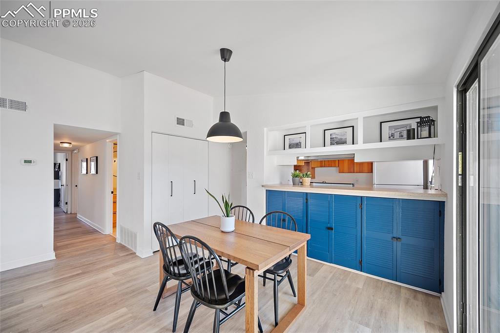 1010 Fontmore Road, Unit D Colorado Springs, CO 80904 - Photo 18 of 43 a view of a dining room with furniture and wooden floor
