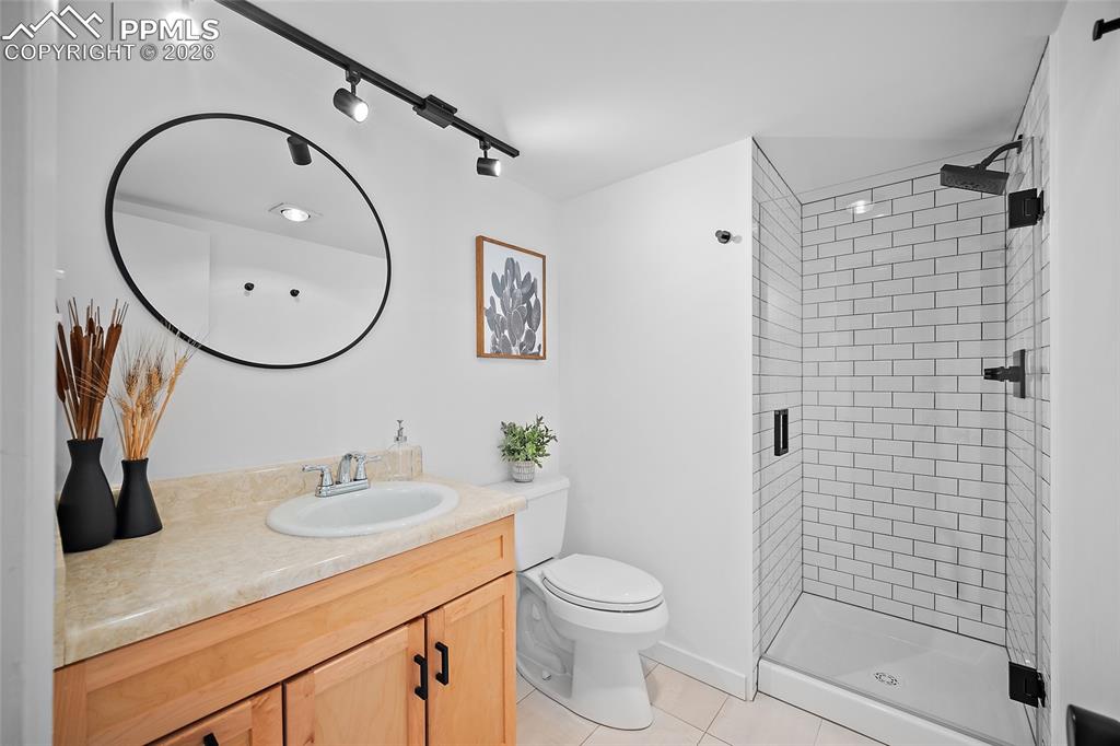 1010 Fontmore Road, Unit D Colorado Springs, CO 80904 - Photo 23 of 43 a bathroom with a sink a toilet and shower