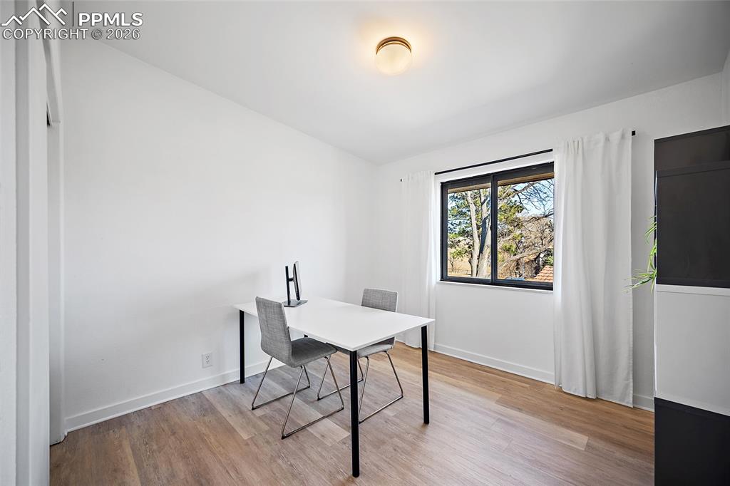 1010 Fontmore Road, Unit D Colorado Springs, CO 80904 - Photo 27 of 43 a workspace with furniture and wooden floor