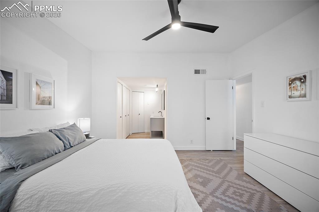 1010 Fontmore Road, Unit D Colorado Springs, CO 80904 - Photo 29 of 43 a bedroom with a large bed and a chandelier