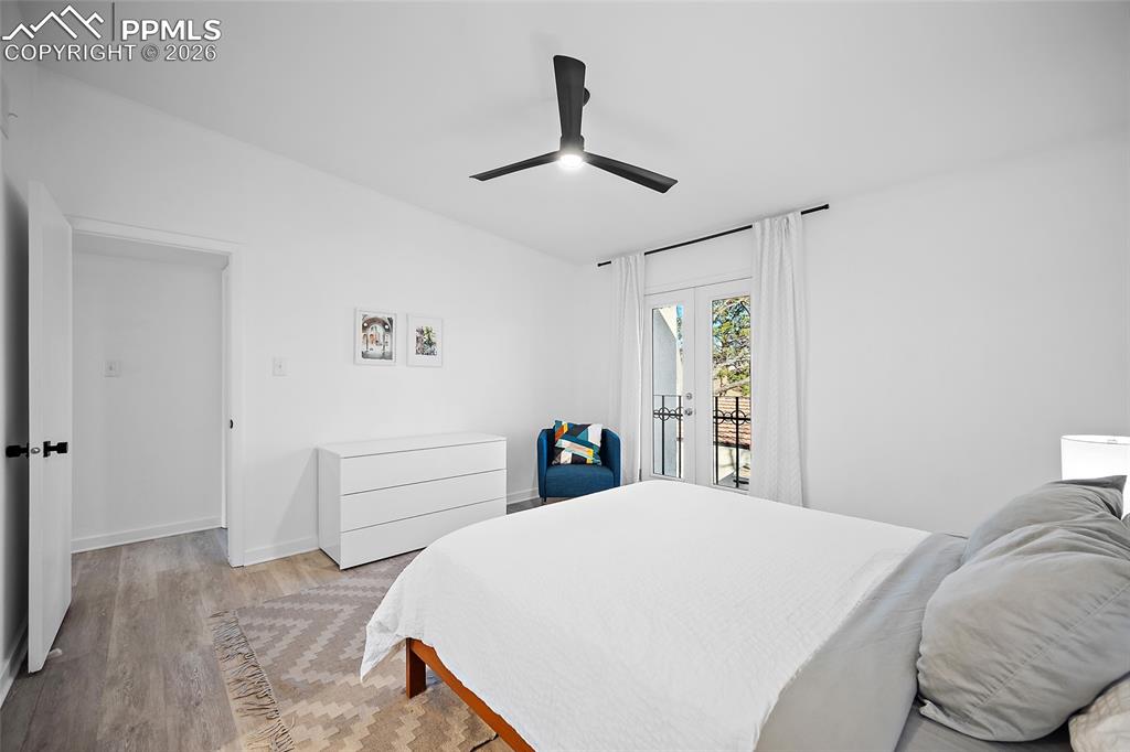 1010 Fontmore Road, Unit D Colorado Springs, CO 80904 - Photo 30 of 43 a bedroom with a large bed and a chandelier