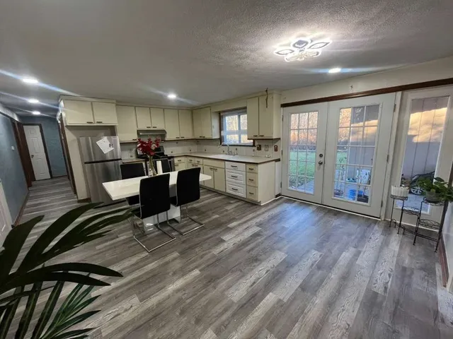 a view of a dining room with furniture window and wooden floor