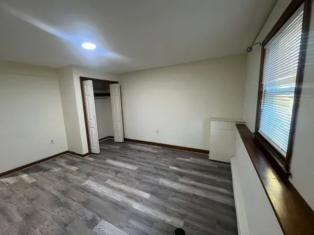 a view of a room with wooden floor and stairs