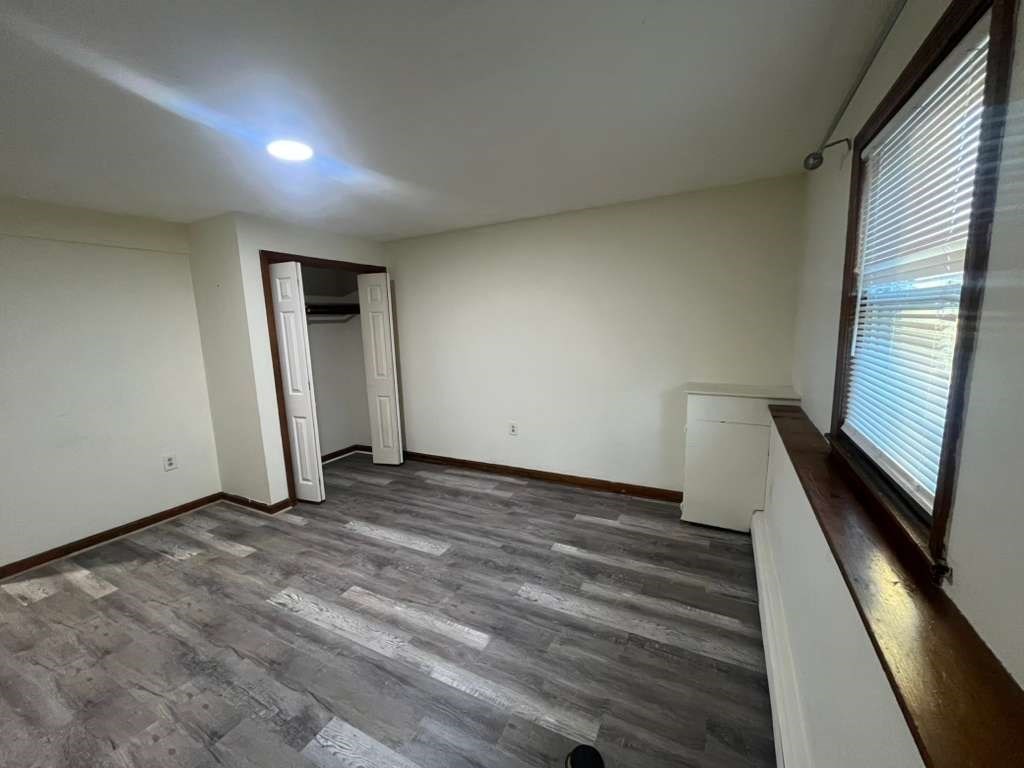 36 Stevens Street, Unit 1 Stoneham, MA 02180 - Photo 4 of 7 a view of a room with wooden floor and stairs