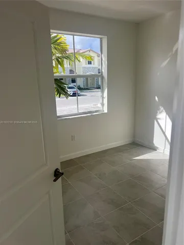 a view of an empty room with a window