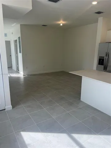 a view of a refrigerator in kitchen