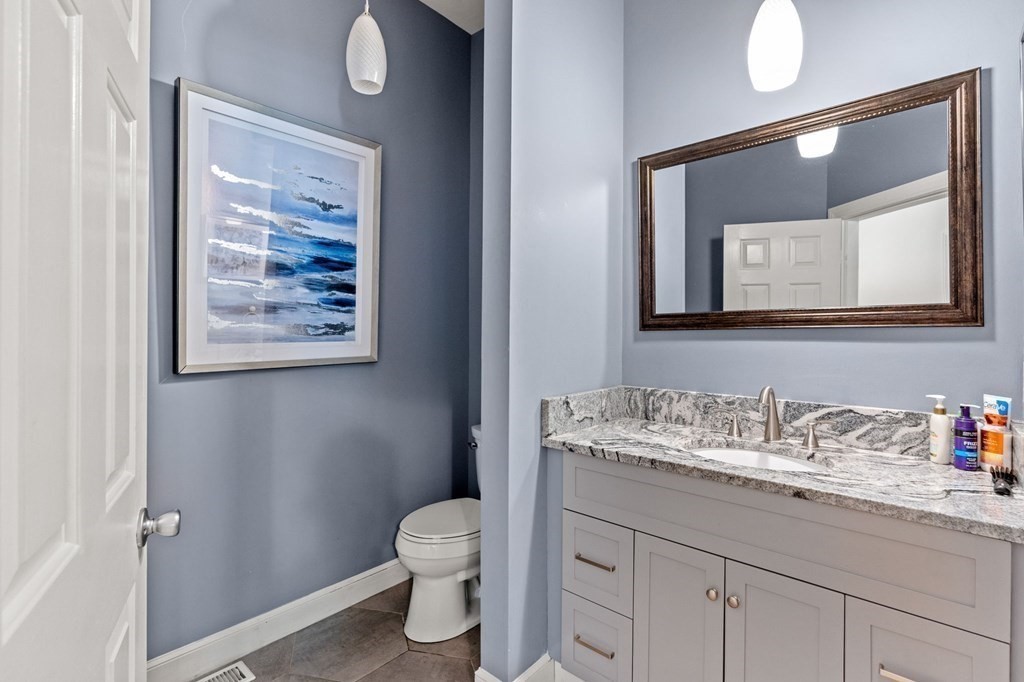 3 Burnham Lane Danvers, MA 01923 - Photo 29 of 41 a bathroom with a toilet sink vanity and mirror