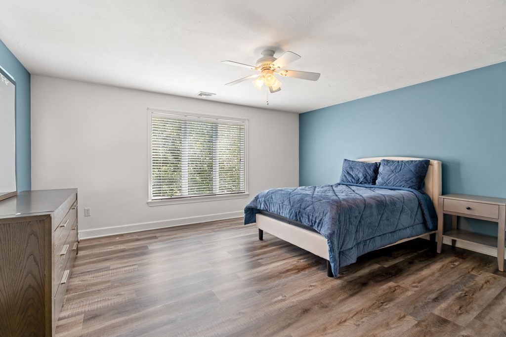 3 Burnham Lane Danvers, MA 01923 - Photo 30 of 41 a bedroom with a bed and a chandelier