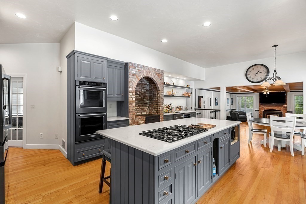 3 Burnham Lane Danvers, MA 01923 - Photo 3 of 41 a kitchen with stainless steel appliances granite countertop a stove top oven a sink dishwasher a dining table and chairs with wooden floor