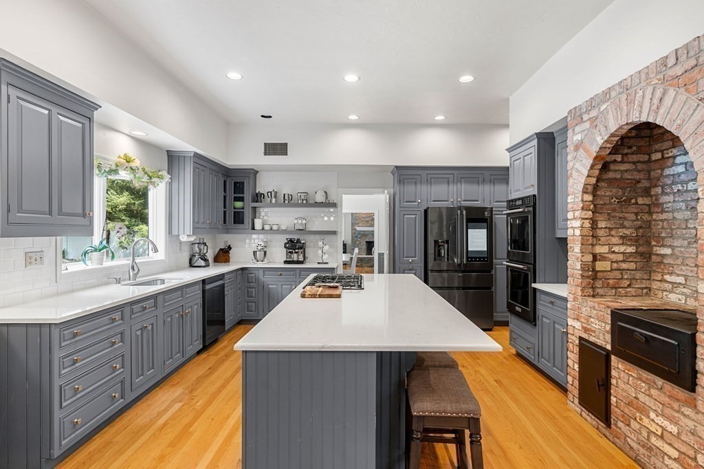 3 Burnham Lane Danvers, MA 01923 - Photo 4 of 41 a kitchen with stainless steel appliances a sink a stove top oven a counter space and cabinets