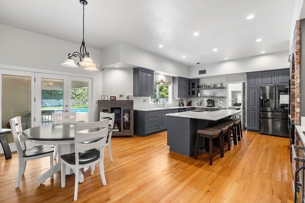3 Burnham Lane Danvers, MA 01923 - Photo 7 of 41 a kitchen with stainless steel appliances kitchen island granite countertop a table chairs and a refrigerator