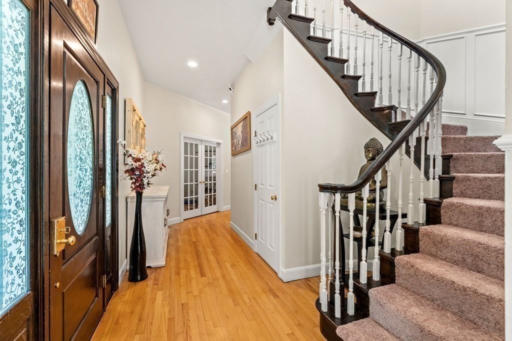 3 Burnham Lane Danvers, MA 01923 - Photo 8 of 41 a view of staircase with lots of frames on wall and wooden floors