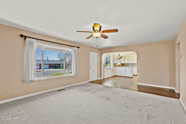an empty room with furniture and a window