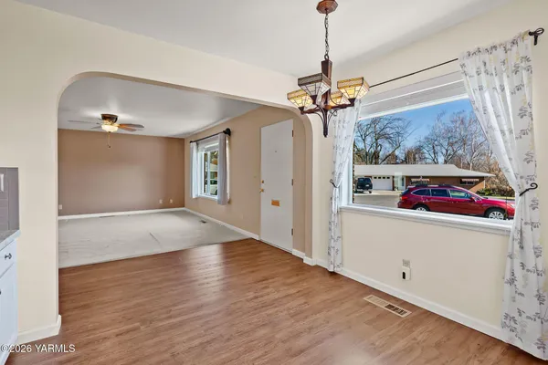 a kitchen with granite countertop a sink stove and cabinets