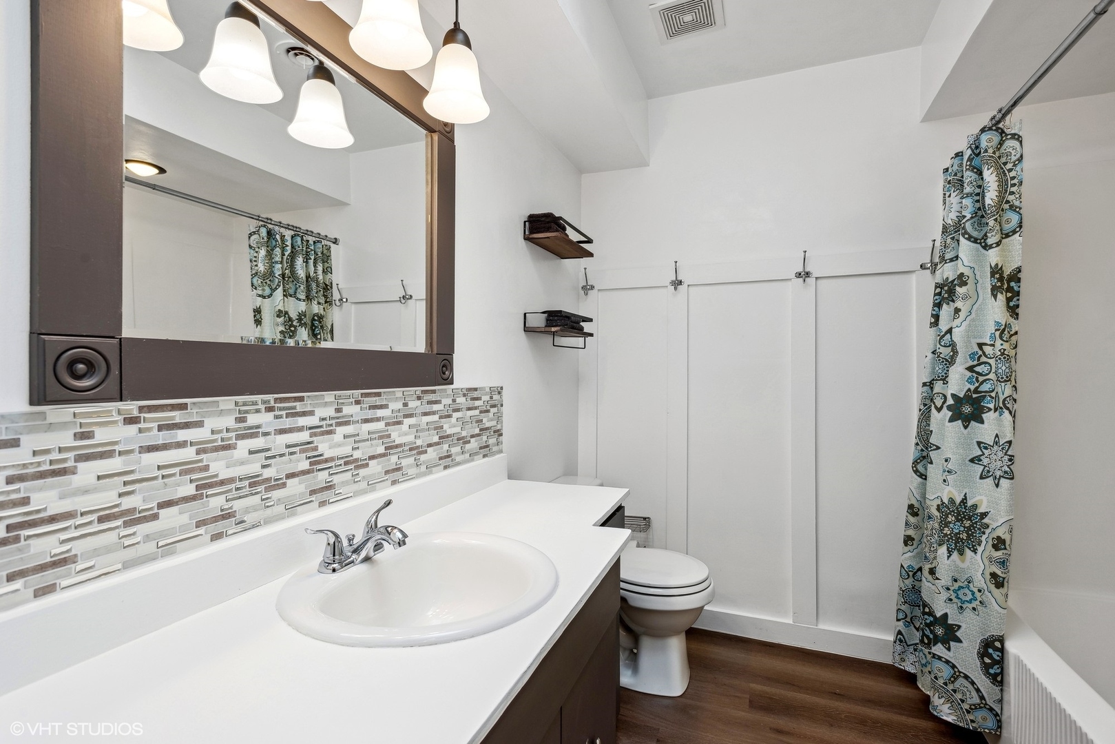 712 McCarthy Road Lemont, IL 60439 - Photo 14 of 24 a bathroom with a sink a toilet and shower curtain