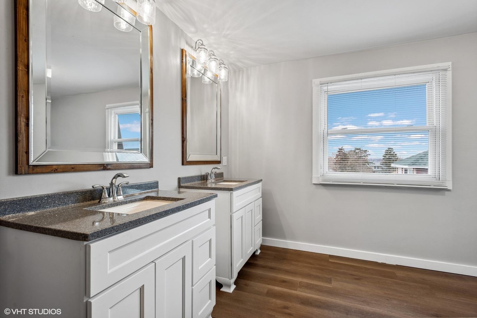 712 McCarthy Road Lemont, IL 60439 - Photo 17 of 24 a bathroom with a double vanity sink and a mirror