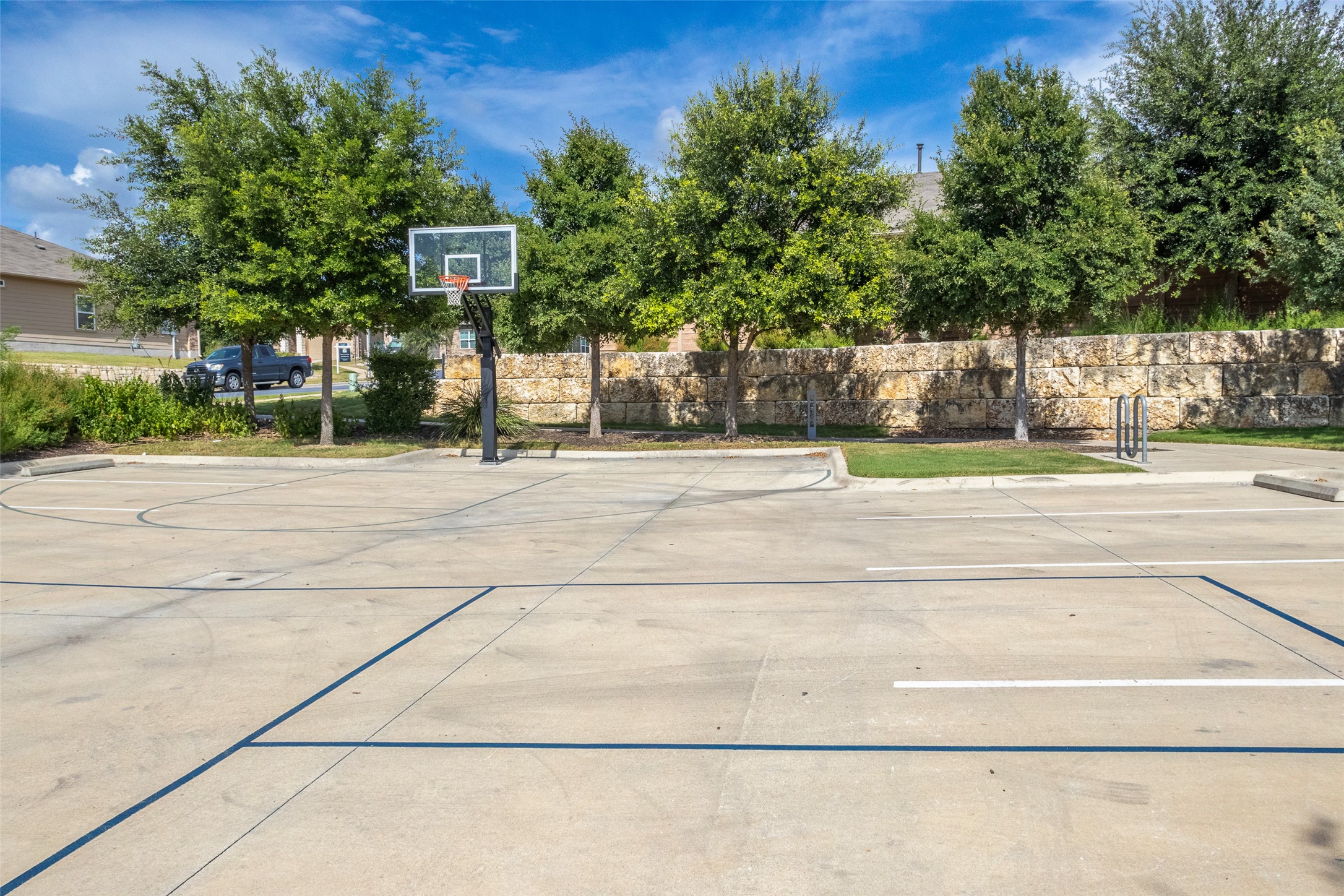 7225 Ranchito Drive Austin, TX 78744 - Photo 33 of 39 Concrete court featuring a basketball hoop for active recreation.