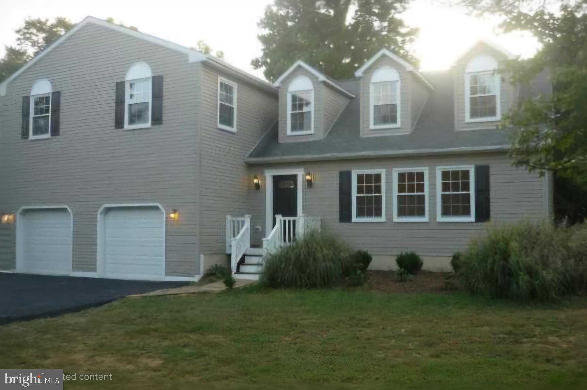 9605 Piscataway Road Clinton, MD 20735 - Photo 1 of 1 a front view of a house with a garden