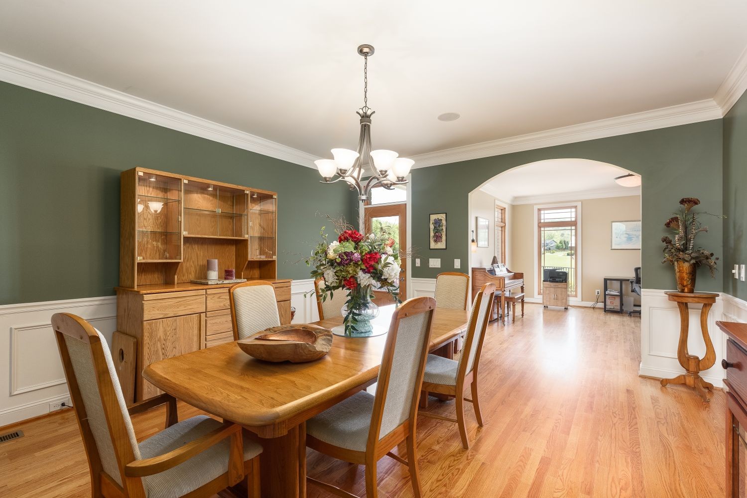 6326 Arno Road Franklin, TN 37064 - Photo 39 of 67 a dining room with furniture a chandelier and wooden floor